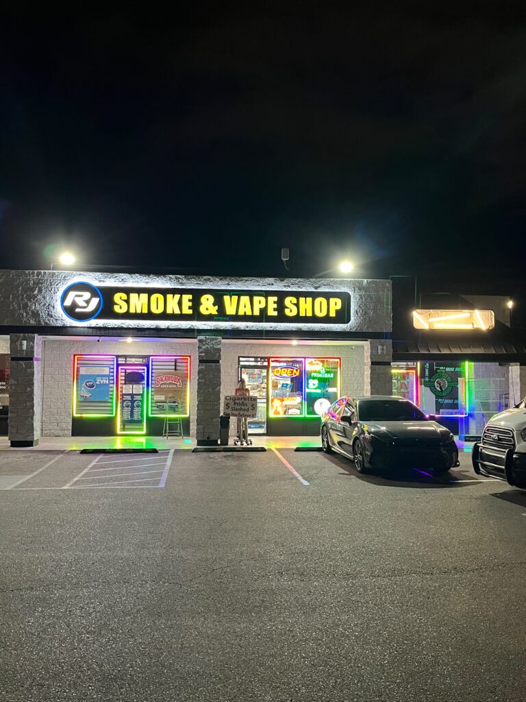 Storefront with illuminated sign and LED window lighting at night