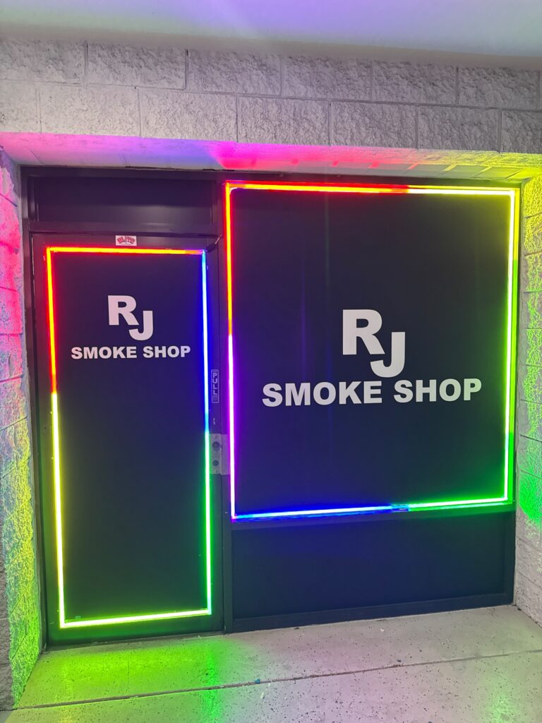 Storefront windows outlined with color-changing LED lighting